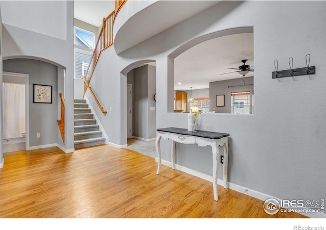 foyer with light hardwood / wood-style floors and ceiling fan