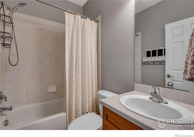 full bathroom featuring vanity, toilet, and shower / bath combo with shower curtain