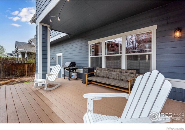 wooden deck featuring a grill