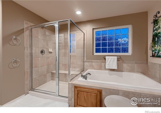 bathroom featuring independent shower and bath