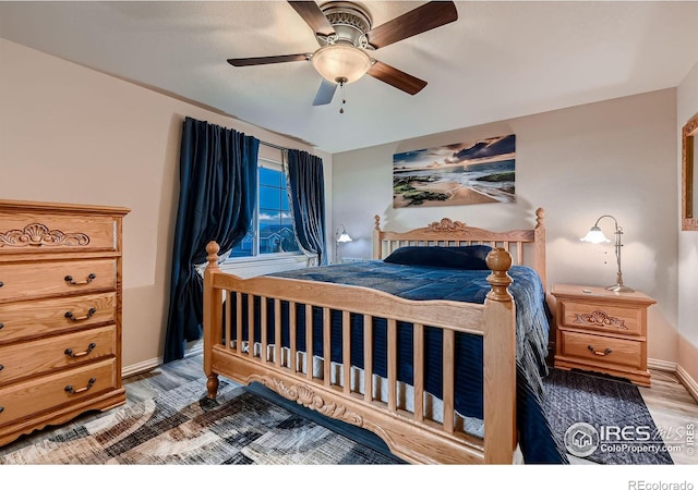 bedroom with hardwood / wood-style flooring and ceiling fan