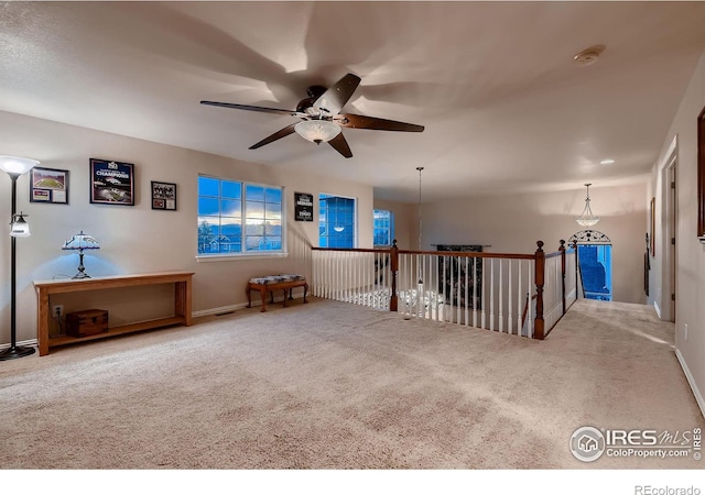 carpeted empty room featuring ceiling fan