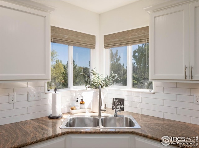 kitchen featuring decorative backsplash and white cabinetry