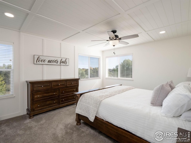 carpeted bedroom featuring multiple windows and ceiling fan