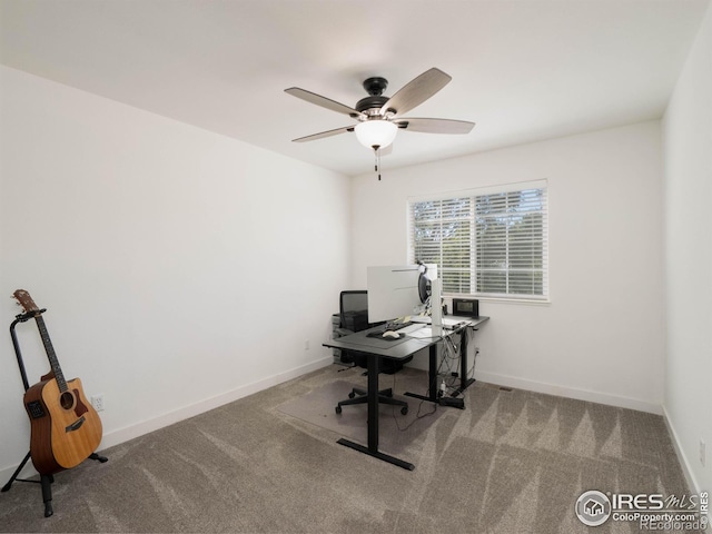 carpeted home office featuring ceiling fan