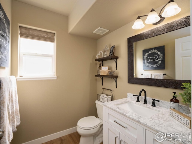 bathroom featuring hardwood / wood-style flooring, vanity, and toilet