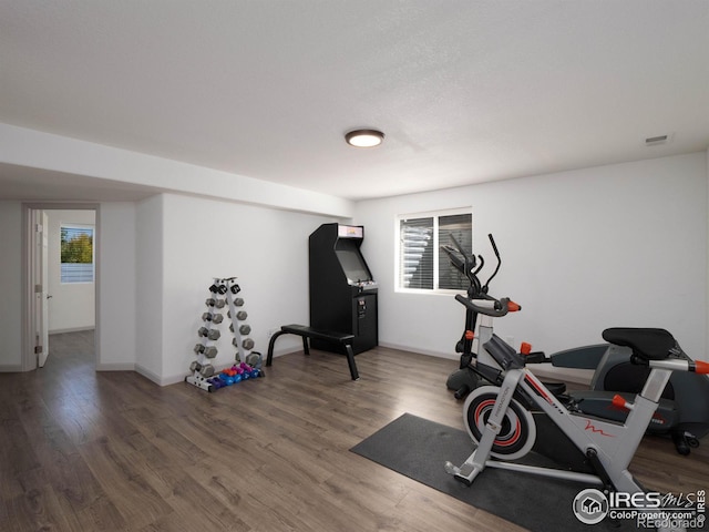 workout room featuring dark wood-type flooring