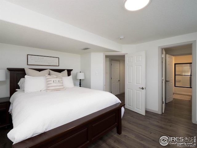 bedroom with dark hardwood / wood-style floors