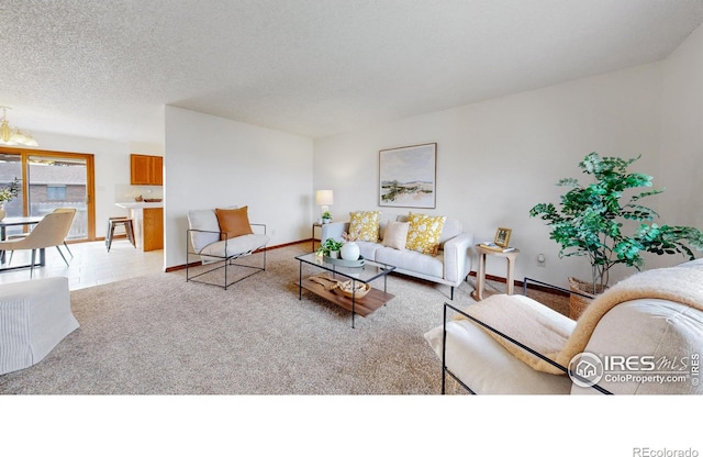 living room with a textured ceiling and light carpet