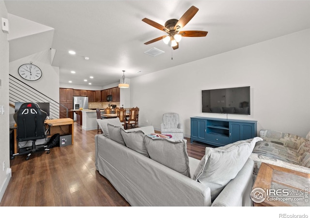 living room featuring dark hardwood / wood-style flooring and ceiling fan