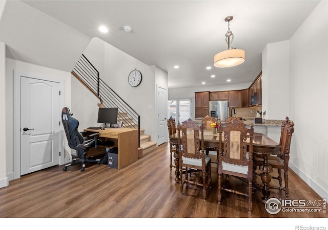 dining area featuring dark wood-type flooring