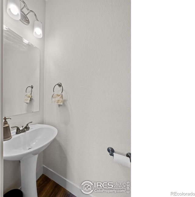 bathroom with wood-type flooring