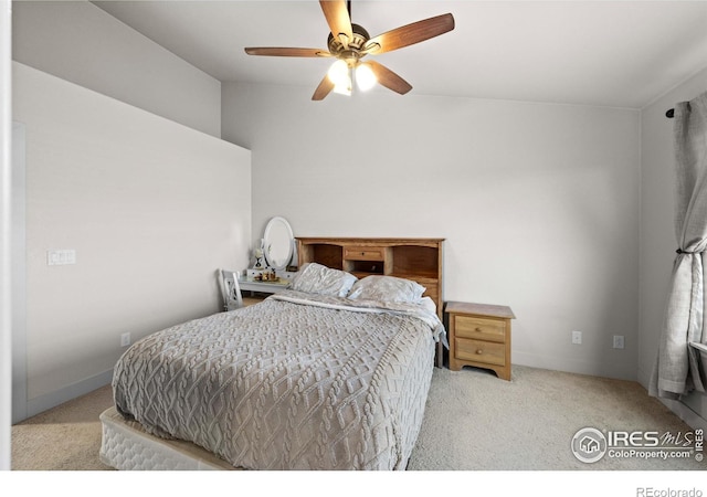 carpeted bedroom featuring lofted ceiling and ceiling fan