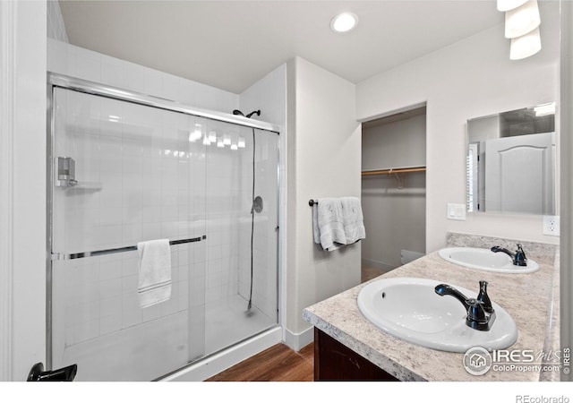 bathroom with an enclosed shower, hardwood / wood-style flooring, and vanity