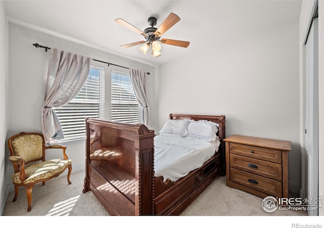 carpeted bedroom with ceiling fan and a closet