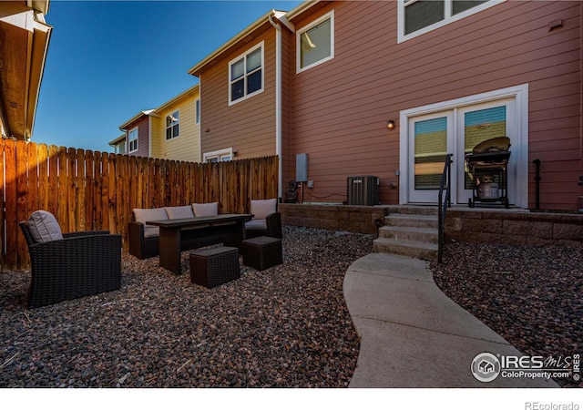 exterior space featuring an outdoor living space and central air condition unit