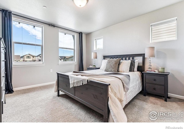 carpeted bedroom with baseboards