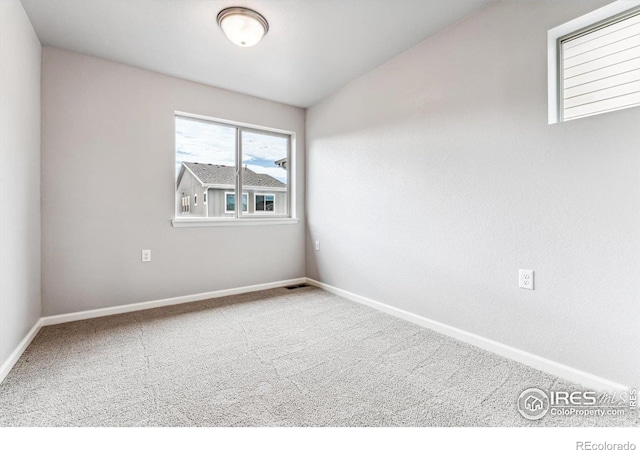 unfurnished room featuring visible vents, baseboards, and carpet floors