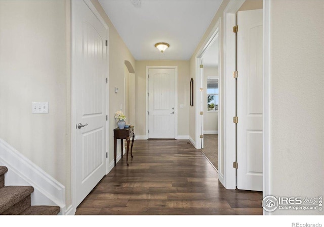 hallway with dark hardwood / wood-style flooring