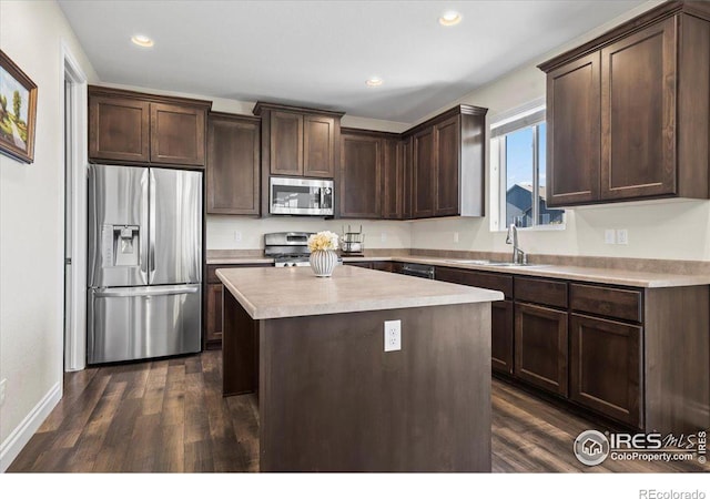 kitchen with a center island, sink, dark hardwood / wood-style floors, appliances with stainless steel finishes, and dark brown cabinetry