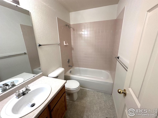 full bathroom with tiled shower / bath, vanity, and toilet