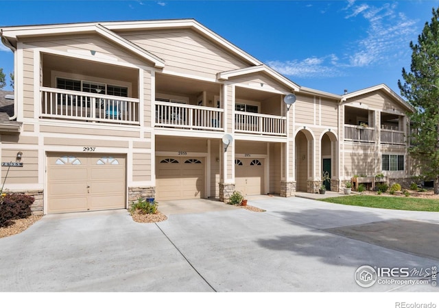 view of front of home featuring a balcony and a garage