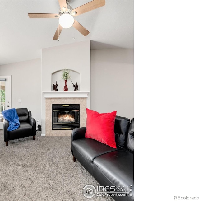 carpeted living room featuring lofted ceiling, ceiling fan, and a fireplace