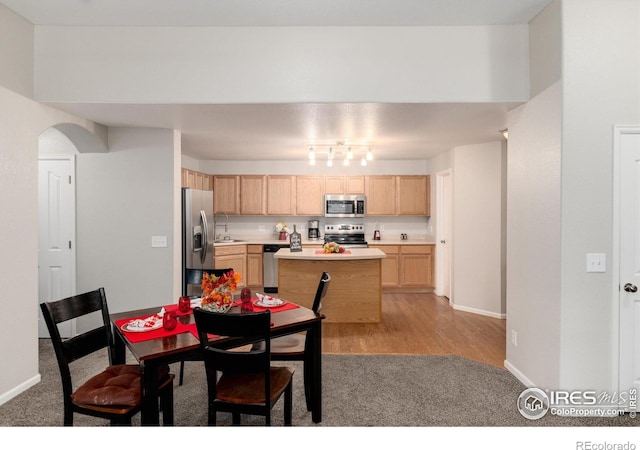 dining area with light wood-type flooring and sink