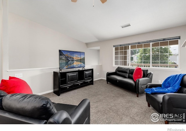 living room featuring ceiling fan, vaulted ceiling, and carpet