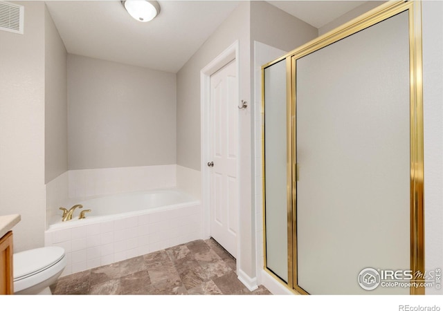 full bathroom featuring vanity, shower with separate bathtub, and toilet