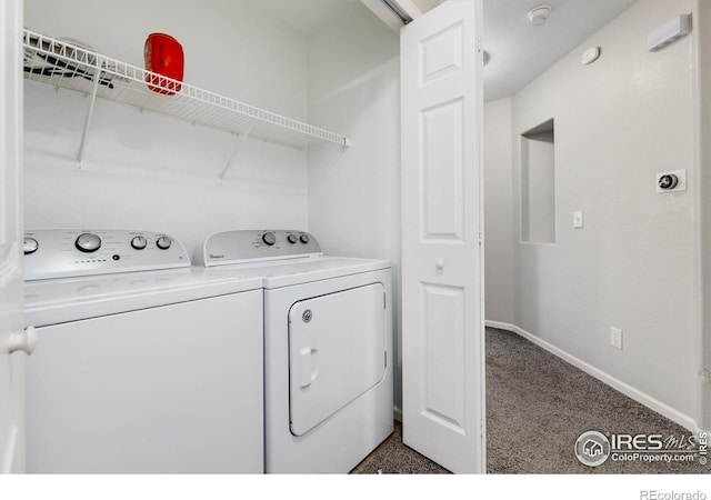 laundry area with washing machine and clothes dryer and dark colored carpet