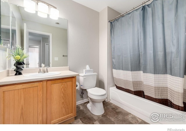 full bathroom featuring shower / tub combo, vanity, and toilet