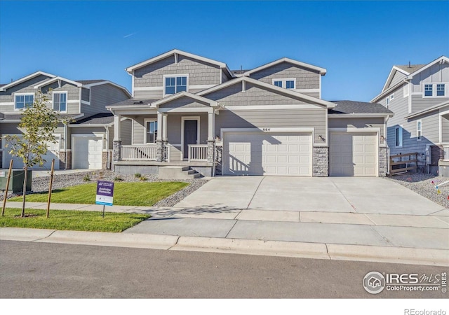 craftsman inspired home with a porch and a garage