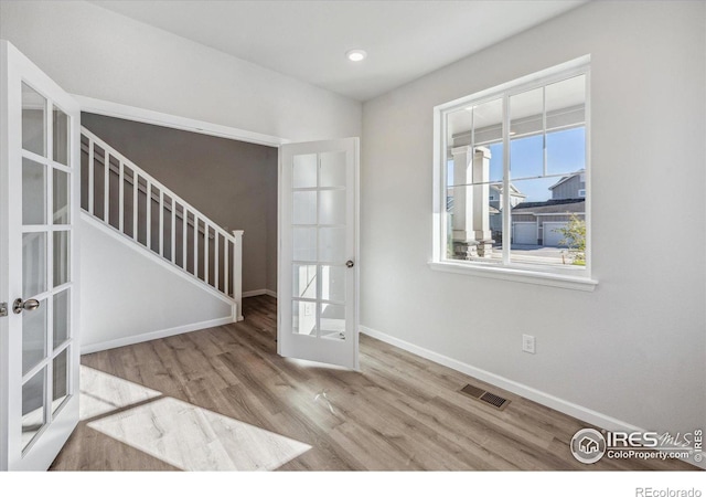 entrance foyer featuring light wood-type flooring and french doors