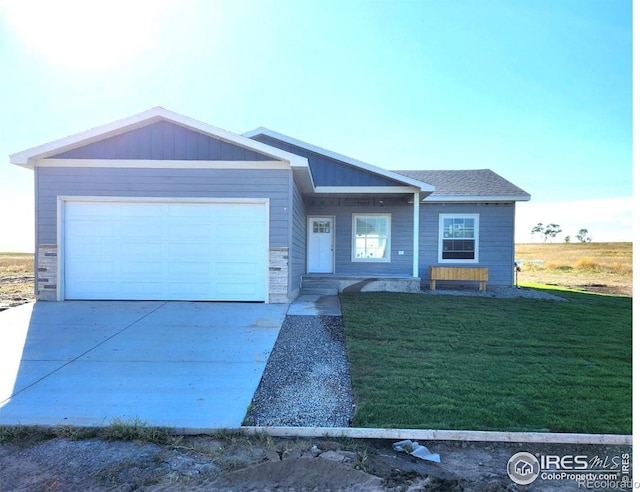 view of front of house featuring a garage and a front lawn