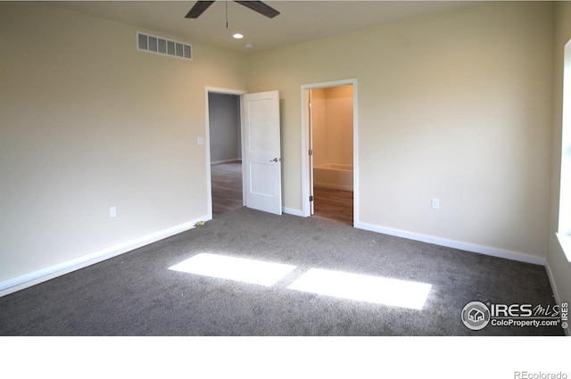 unfurnished bedroom featuring dark carpet and ceiling fan