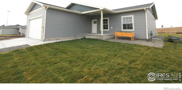 view of front of house with a garage and a front lawn