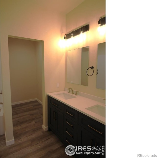 bathroom featuring hardwood / wood-style flooring and vanity