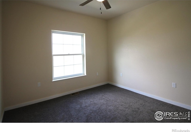 unfurnished room featuring ceiling fan and carpet floors