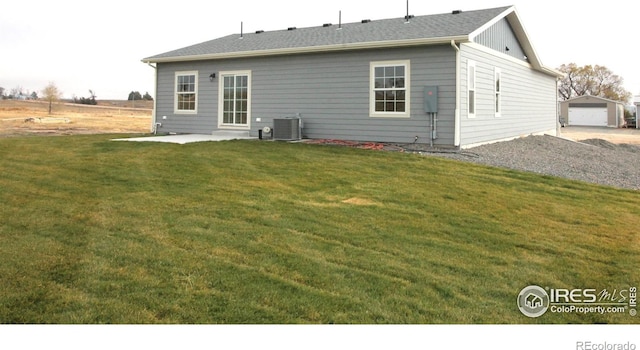 back of house featuring central AC, a patio area, and a yard