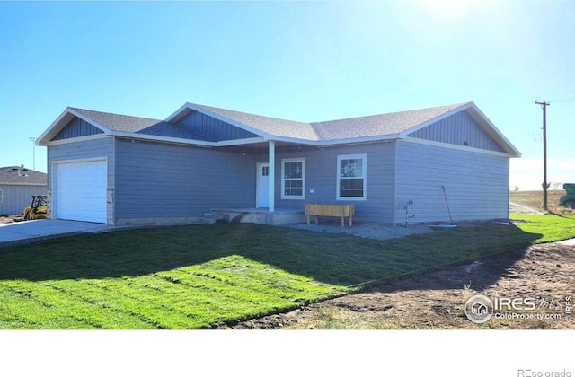 ranch-style house with a garage and a front lawn