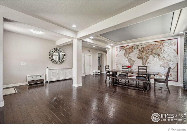 dining room featuring baseboards, wood finished floors, and recessed lighting