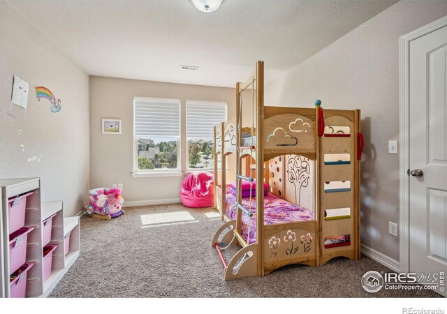 bedroom with baseboards, visible vents, and carpet flooring