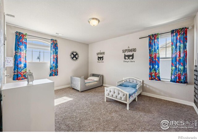 carpeted bedroom with visible vents and baseboards