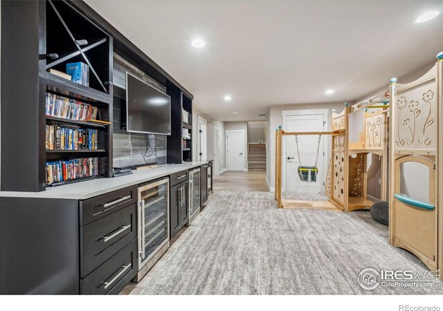 bar featuring light carpet, tasteful backsplash, wine cooler, and recessed lighting