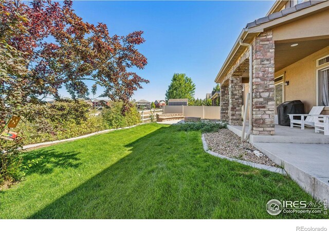 view of yard featuring a patio and fence