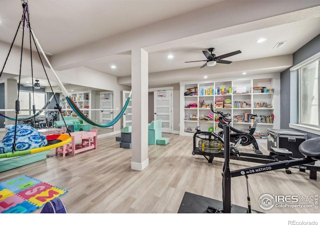 interior space with recessed lighting, wood finished floors, a ceiling fan, baseboards, and visible vents