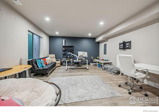 living room with visible vents, wood finished floors, electric panel, and recessed lighting