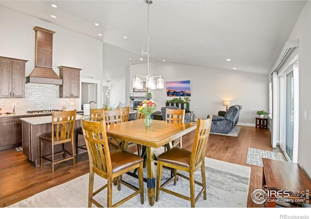 dining room featuring dark hardwood / wood-style floors and high vaulted ceiling