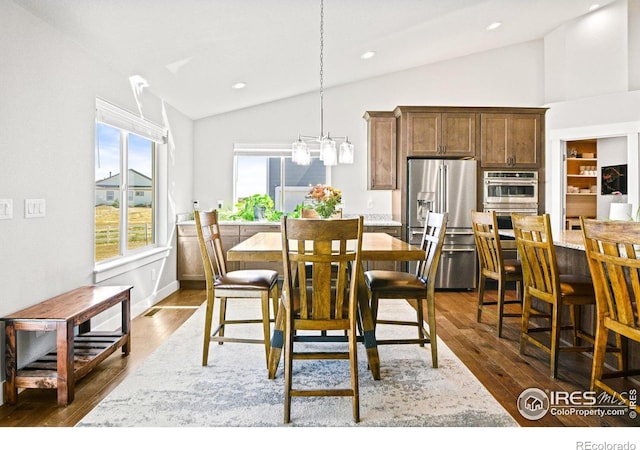 dining room featuring dark hardwood / wood-style floors and lofted ceiling